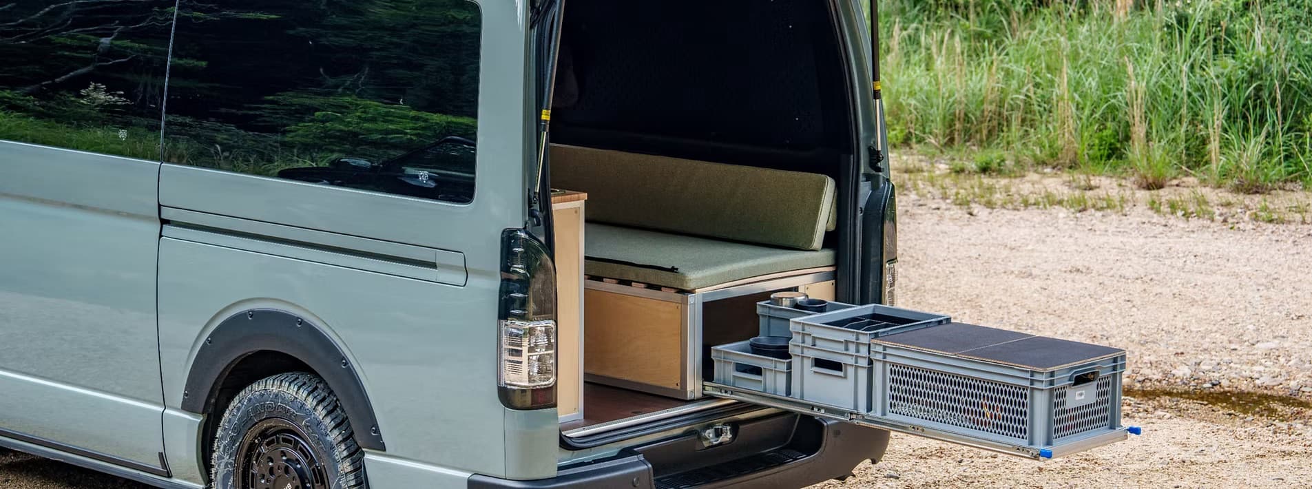 Van exterior — rear door open showing modular system