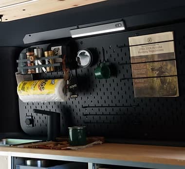 Pegboard wall organiser with hooks and accessories