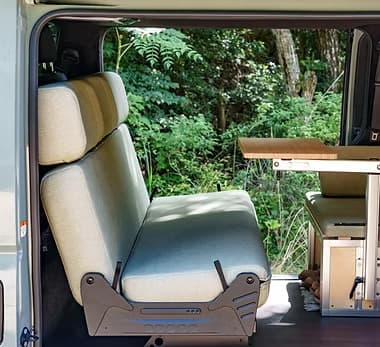 Rear seating with green upholstery and modular side cabinet