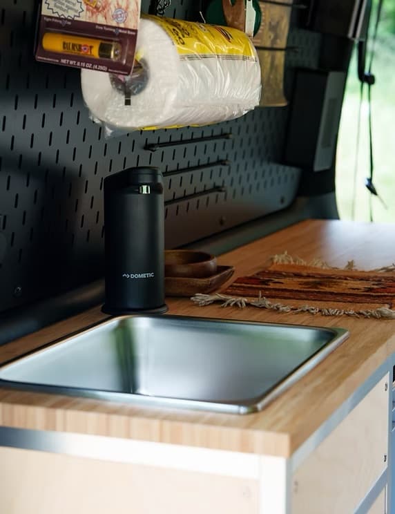 Dometic sink with bamboo countertop and pegboard storage
